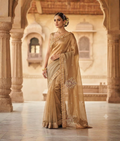 Golden tussar silk saree with zardozi, moti and sequence work