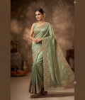 Light green saree with an ornate scalloped border and gota patti, zardozi, sequence and moti work