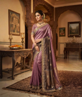 Purple soft silk handloom saree with a golden-toned decorative border and scattered motifs