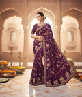 Purple handloom saree with colourful floral thread patterns and a decorative border