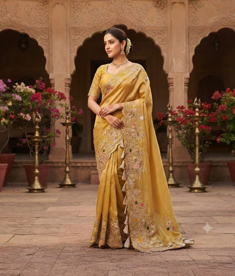 Yellow tissue georgette saree with zardozi work and an ornate decorative border