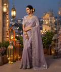 Light purple saree with a scalloped decorative border and scattered motifs