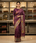 Purple saree with a colourful floral patterned border, scattered motifs and tasselled pallu