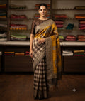 Chiku and grey checked saree with a patterned border and yellow motif-detailed aanchal